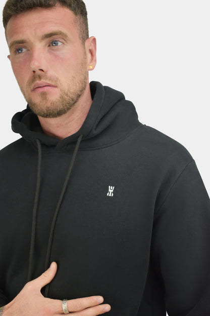 Small embroidered Ytinu crest on the Obsidian black hoodie